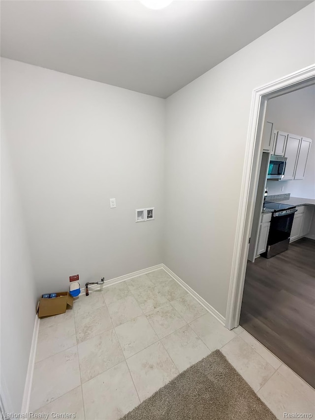 253 Devonshire Dr Unit 2, Lapeer, MI 48446 - laundry room with hookup for a washing machine and light tile patterned flooring
