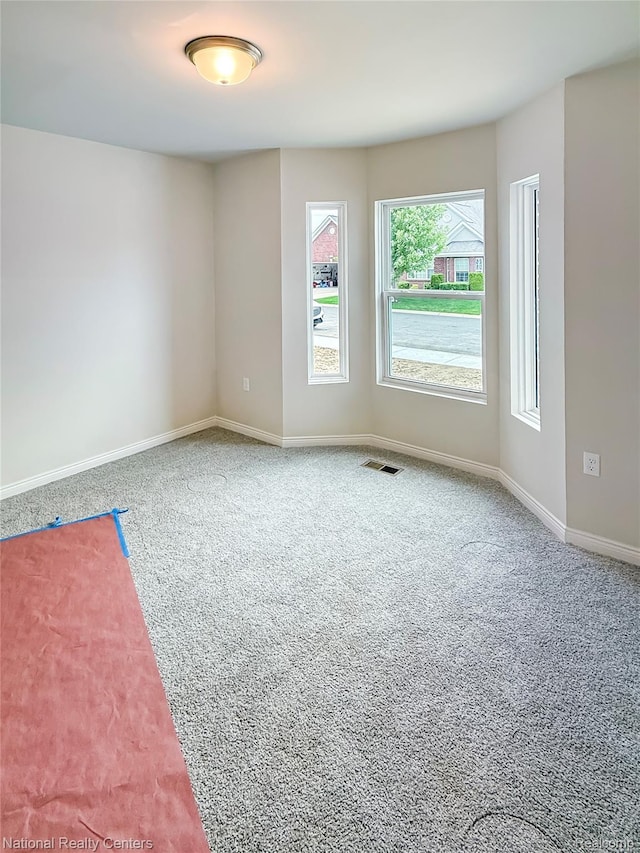 253 Devonshire Dr Unit 2, Lapeer, MI 48446 - carpeted empty room featuring baseboards
