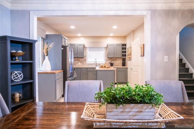 17417 San Juan Dr, Detroit, MI 48221 - dining space with arched walkways, stairway, and recessed lighting