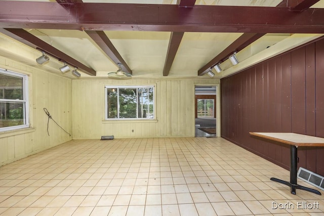 7985 Island View Dr, Newaygo, MI 49337 - tiled spare room with beam ceiling, track lighting, and wooden walls