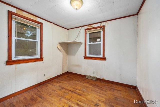 7985 Island View Dr, Newaygo, MI 49337 - empty room featuring crown molding and wood finished floors