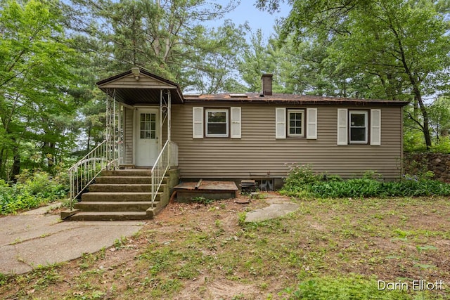 7985 Island View Dr, Newaygo, MI 49337 - view of front facade featuring a chimney