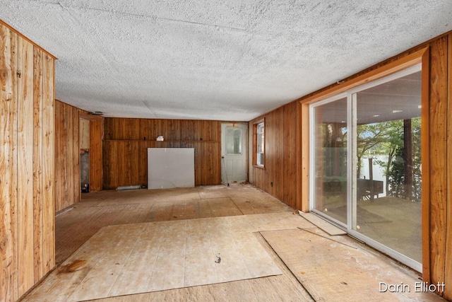 7985 Island View Dr, Newaygo, MI 49337 - unfurnished room with wooden walls and a textured ceiling