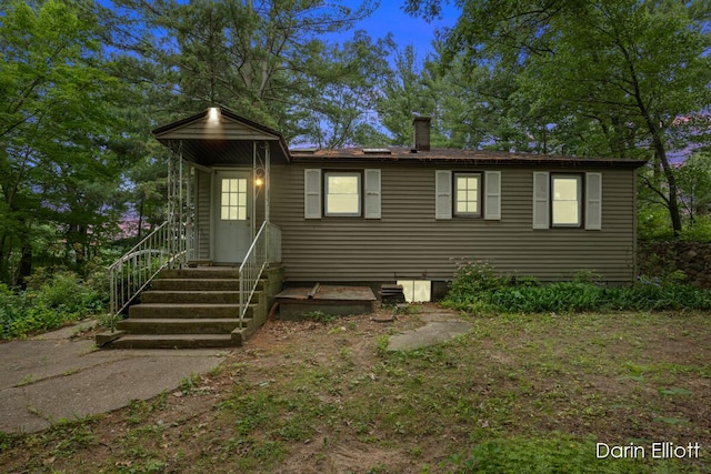 7985 Island View Dr, Newaygo, MI 49337 - view of front facade featuring a chimney