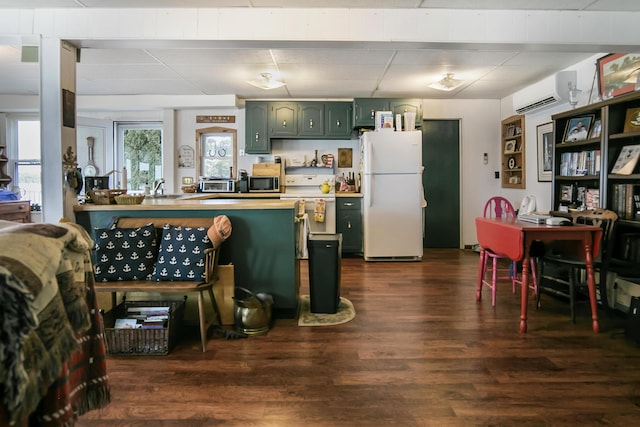 68534 Hill St, Sturgis, MI 49091 - kitchen featuring freestanding refrigerator, green cabinetry, a wall mounted AC, stainless steel microwave, and dark wood finished floors