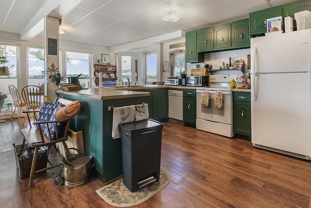 68534 Hill St, Sturgis, MI 49091 - kitchen with green cabinets, white appliances, a peninsula, a paneled ceiling, and dark wood-type flooring