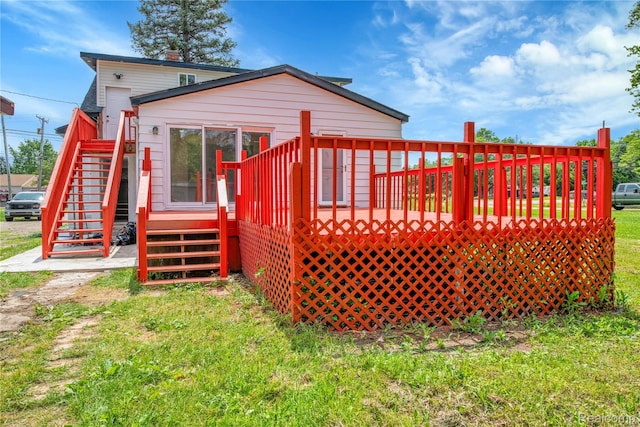 134 W Auburn Rd, Rochester, MI 48307 - rear view of house with stairs, a wooden deck, and a lawn