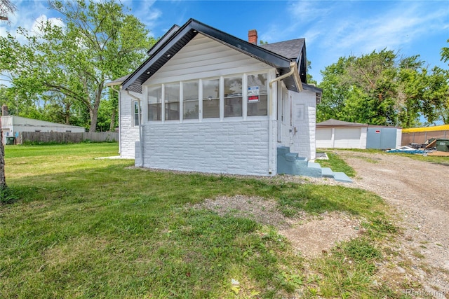 134 W Auburn Rd, Rochester, MI 48307 - view of front of property featuring stone siding, a chimney, entry steps, an outbuilding, and driveway