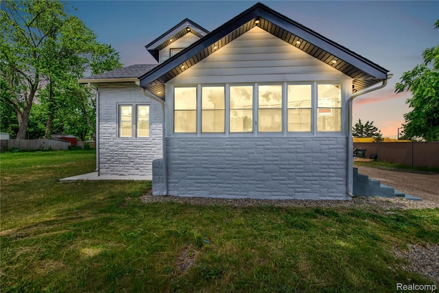 134 W Auburn Rd, Rochester, MI 48307 - property exterior at dusk with stone siding