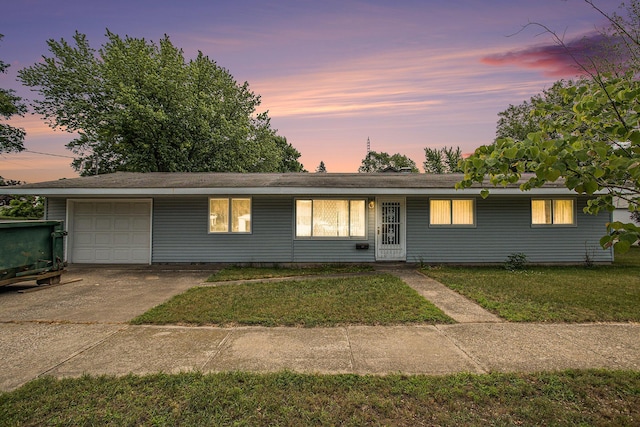 712 N Rath Ave, Ludington, MI 49431 - ranch-style home featuring a garage, a front yard, and concrete driveway
