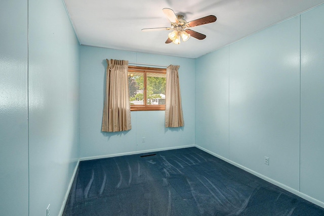 712 N Rath Ave, Ludington, MI 49431 - empty room with a ceiling fan and dark colored carpet