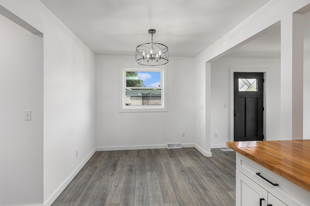 287 Somerset Dr, Brooklyn, MI 49230 - unfurnished dining area featuring a chandelier and dark wood finished floors