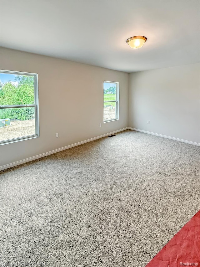 281 Devonshire Dr Unit 6, Lapeer, MI 48446 - empty room with carpet flooring