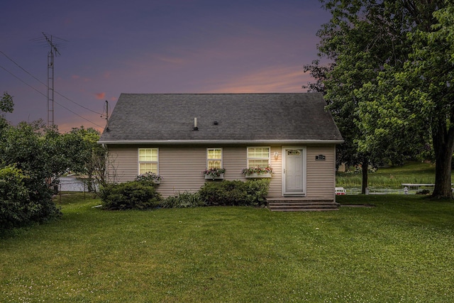 210 Oak Grove Dr, Brooklyn, MI 49230 - back of property at dusk with a yard and roof with shingles