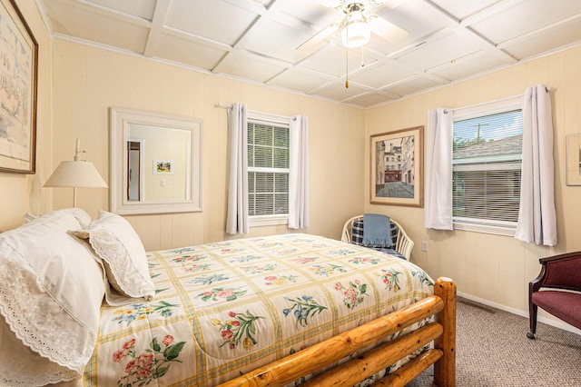 210 Oak Grove Dr, Brooklyn, MI 49230 - carpeted bedroom with coffered ceiling, ceiling fan, and wooden walls