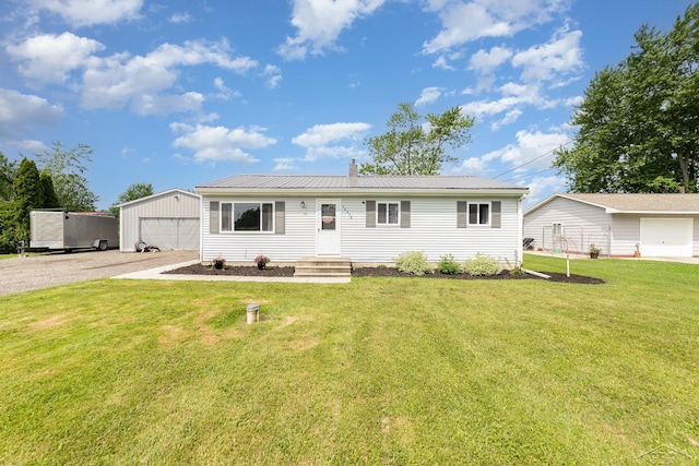 14079 Elms Rd, Montrose, MI 48457 - ranch-style house with an outbuilding, a chimney, a front yard, a metal roof, and a detached garage