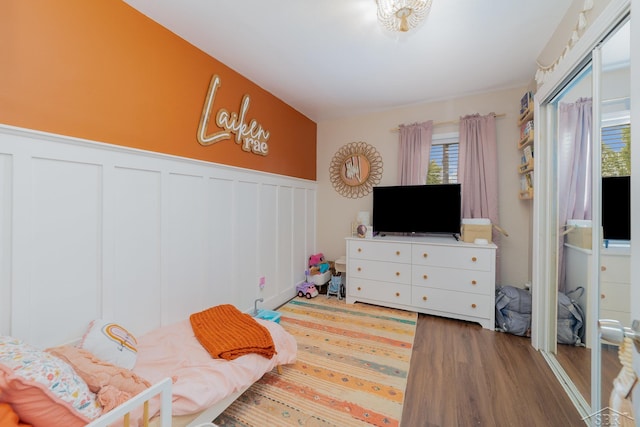 14079 Elms Rd, Montrose, MI 48457 - bedroom featuring wood finished floors, a wainscoted wall, and a decorative wall