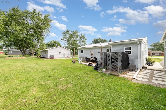 14079 Elms Rd, Montrose, MI 48457 - view of grassy yard featuring a patio area