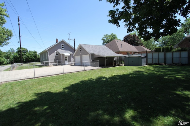 6257 E Dunbar Rd, Monroe, MI 48161 - fenced backyard with a shed, driveway, and an attached garage