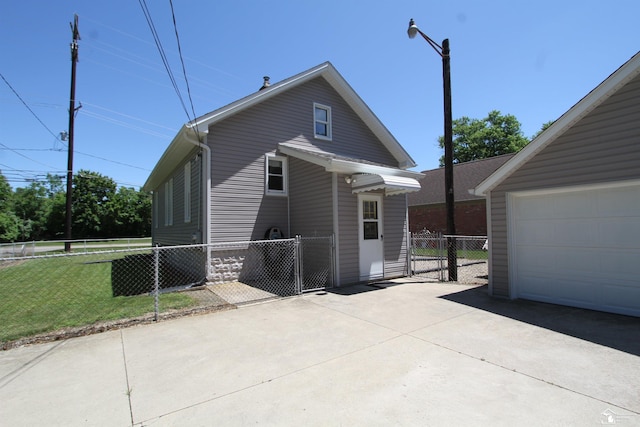 6257 E Dunbar Rd, Monroe, MI 48161 - view of front of property featuring a garage, a gate, and concrete driveway