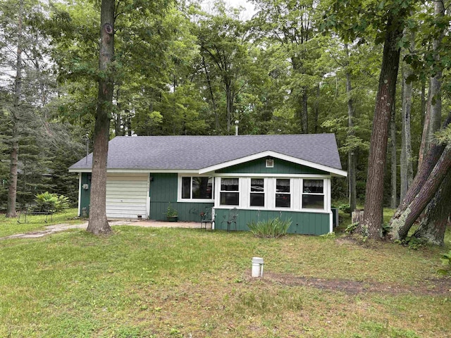 4384 Loud Dam Rd, Glennie, MI 48737 - view of front of house featuring a front yard and a shingled roof
