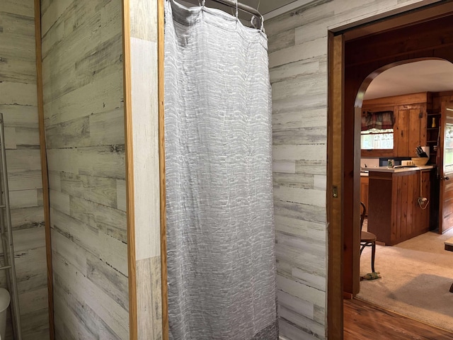 4384 Loud Dam Rd, Glennie, MI 48737 - full bath with wood walls, vanity, and a shower with curtain
