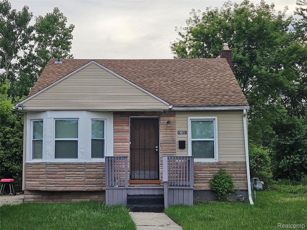 18021 Ferguson St, Detroit, MI 48235 - bungalow-style house with roof with shingles and a chimney