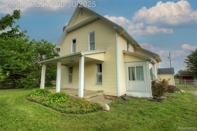 3092 Dillon Rd, Flushing, MI 48433 - rear view of property with a yard, a porch, and a chimney