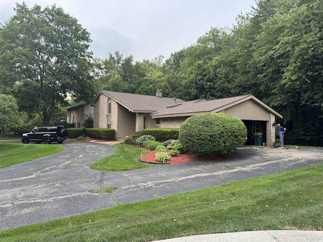 28902 Creek Bend Dr, Farmington Hills, MI 48331 - view of property exterior with driveway, a chimney, roof with shingles, and a lawn