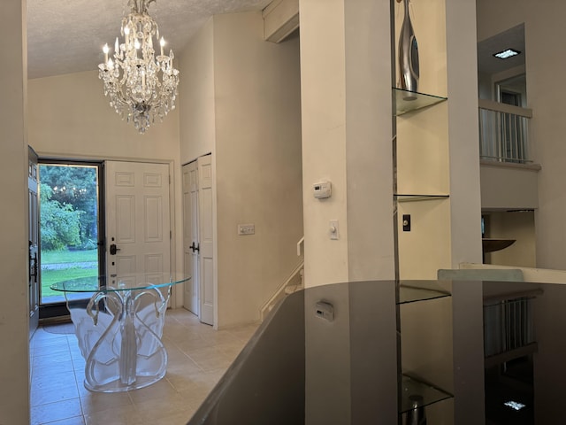 28902 Creek Bend Dr, Farmington Hills, MI 48331 - foyer featuring a chandelier, light tile patterned floors, a towering ceiling, and a textured ceiling