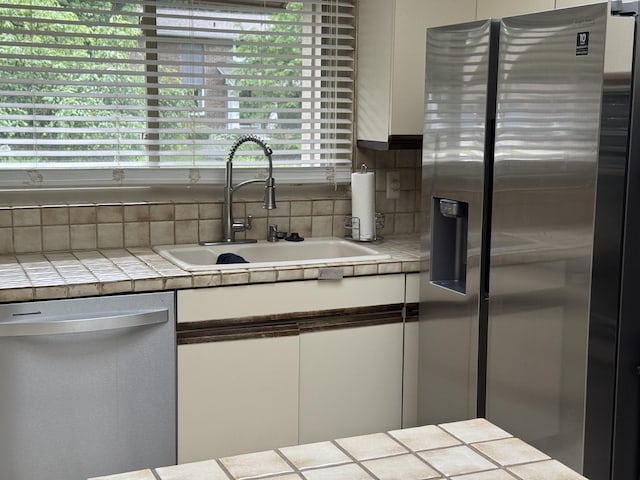 28902 Creek Bend Dr, Farmington Hills, MI 48331 - kitchen featuring stainless steel appliances, white cabinets, tile counters, and tasteful backsplash