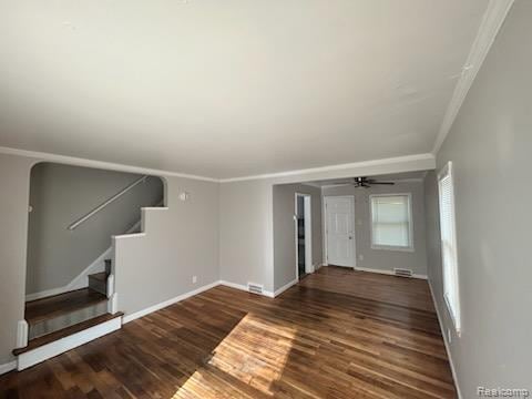 15452 Southfield Rd, Detroit, MI 48223 - unfurnished living room featuring ornamental molding, wood finished floors, and stairway