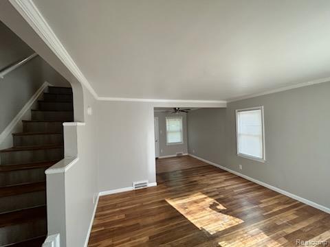 15452 Southfield Rd, Detroit, MI 48223 - unfurnished room with crown molding, a ceiling fan, stairs, and wood finished floors