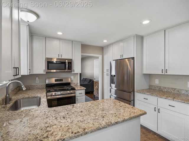 29553 Pinto Dr, Warren, MI 48093 - kitchen featuring stainless steel appliances, recessed lighting, light stone countertops, and white cabinets