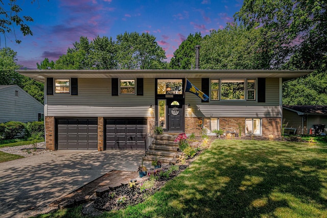 3042 Kevin St, Saint Joseph, MI 49085 - raised ranch with brick siding, a garage, a front yard, and concrete driveway