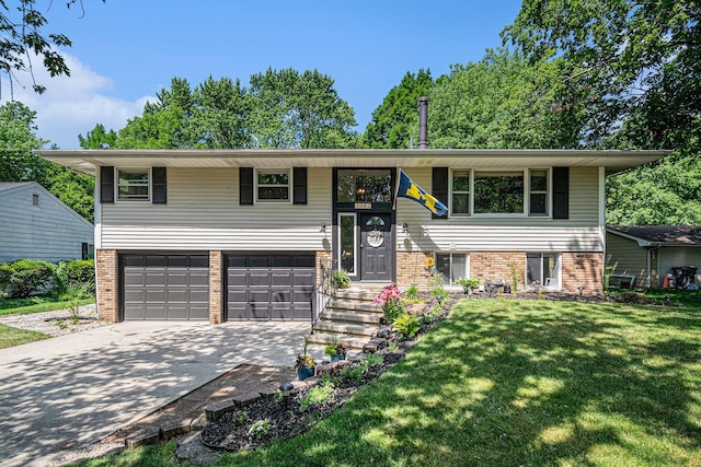 3042 Kevin St, Saint Joseph, MI 49085 - bi-level home featuring a front lawn, an attached garage, brick siding, and concrete driveway