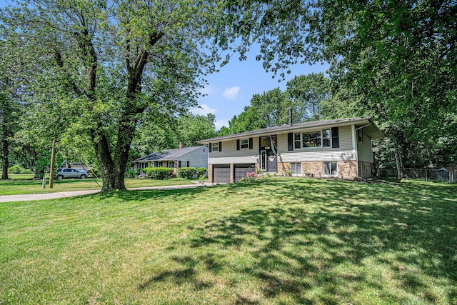 3042 Kevin St, Saint Joseph, MI 49085 - raised ranch with an attached garage, concrete driveway, and brick siding
