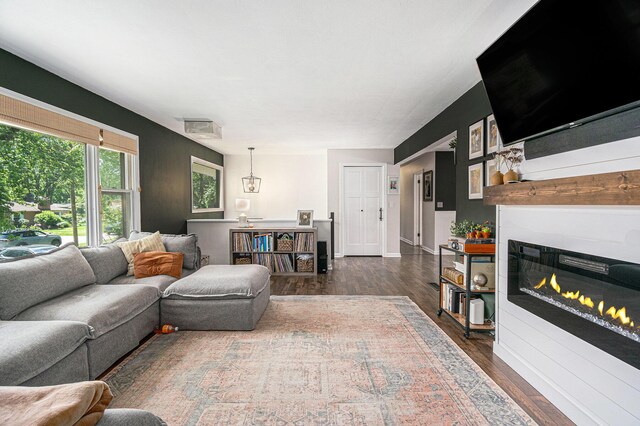 3042 Kevin St, Saint Joseph, MI 49085 - living area featuring dark wood-type flooring and a glass covered fireplace