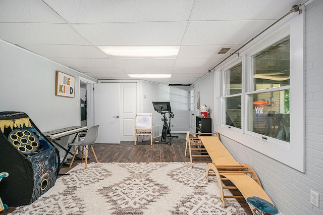 3042 Kevin St, Saint Joseph, MI 49085 - playroom with a drop ceiling, wood finished floors, and brick wall
