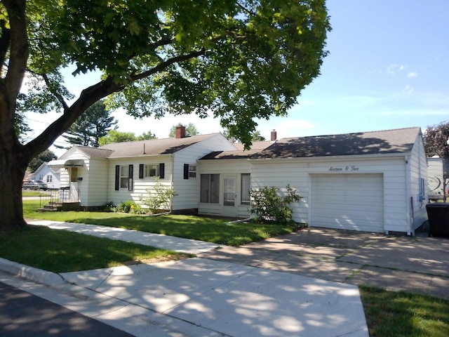 1602 Blakely Ave, Jackson, MI 49202 - ranch-style home with a garage, concrete driveway, a front lawn, and a chimney
