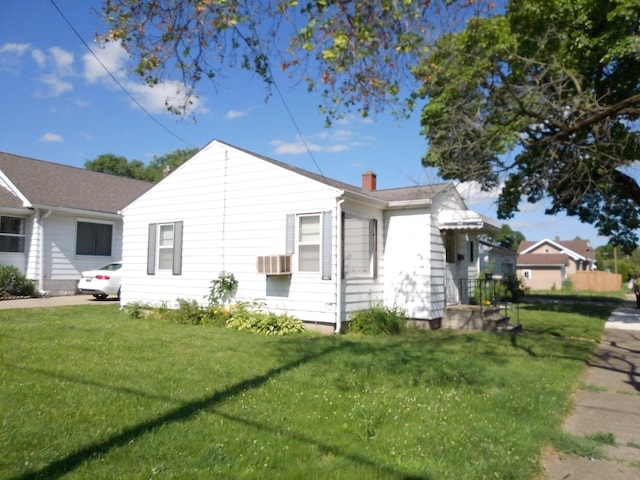 1602 Blakely Ave, Jackson, MI 49202 - view of property exterior featuring a lawn, a chimney, and cooling unit