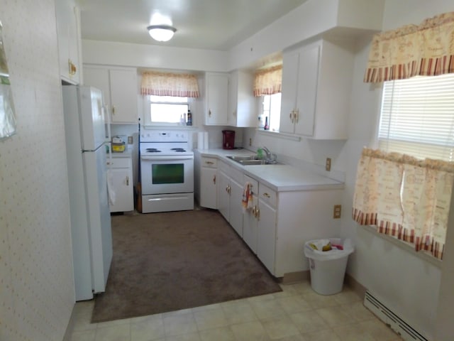 1602 Blakely Ave, Jackson, MI 49202 - kitchen with white appliances, a baseboard heating unit, white cabinets, and light countertops