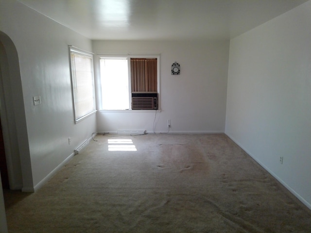 1602 Blakely Ave, Jackson, MI 49202 - spare room with arched walkways, carpet floors, and cooling unit