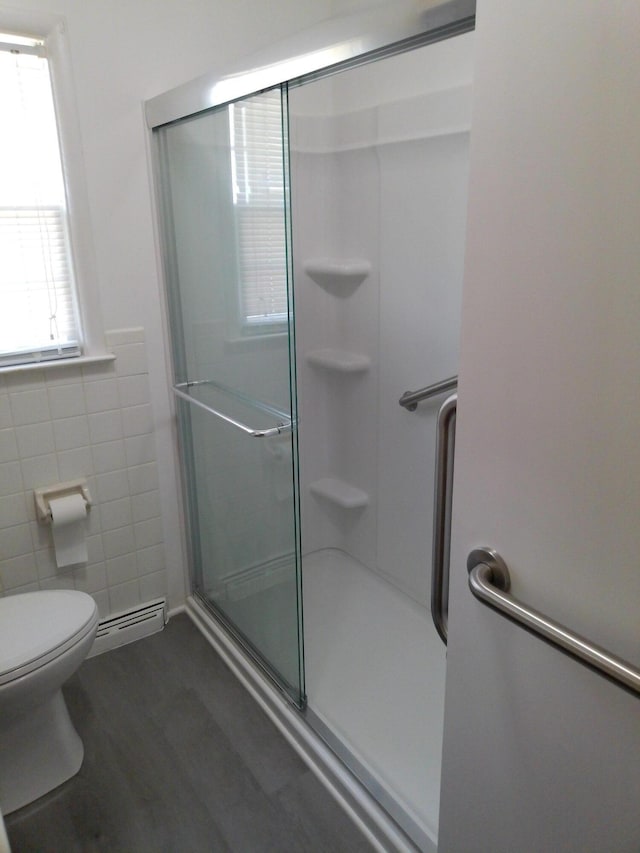 1602 Blakely Ave, Jackson, MI 49202 - full bath with a shower stall, tile walls, and a baseboard heating unit
