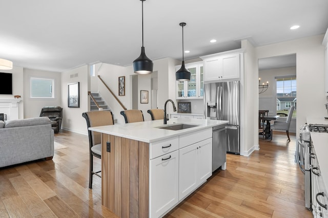 8114 Turning Stone, Kalamazoo, MI 49009 - kitchen with open floor plan, a breakfast bar area, appliances with stainless steel finishes, white cabinets, and glass insert cabinets