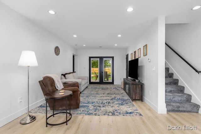 412 S Woodworth St, Corunna, MI 48817 - living room with stairs, light wood finished floors, recessed lighting, and french doors