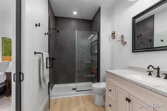 412 S Woodworth St, Corunna, MI 48817 - ensuite bathroom featuring vanity, a stall shower, and wood finished floors