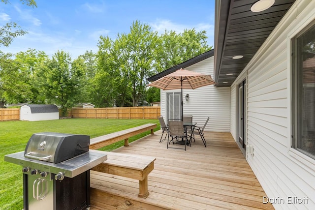 412 S Woodworth St, Corunna, MI 48817 - wooden deck with outdoor dining area, a grill, a fenced backyard, and a shed