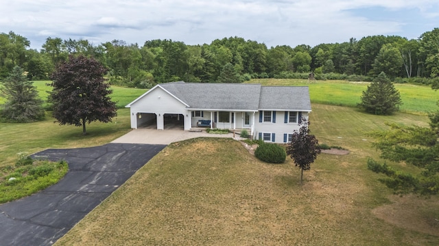 1684 W W County Line Rd, Sand Lake, MI 49343 - ranch-style home with a front yard, asphalt driveway, a garage, and covered porch