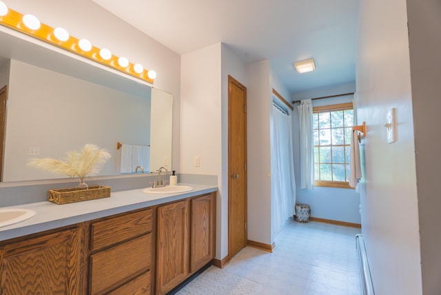 1684 W W County Line Rd, Sand Lake, MI 49343 - bathroom featuring double vanity, tile patterned floors, and a baseboard radiator